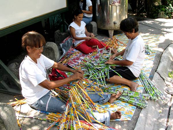 Talented women weaving juice pouch purses